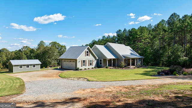 view of front of property featuring an outdoor structure, a front lawn, and covered porch