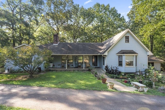 view of front of house with a front yard and a porch