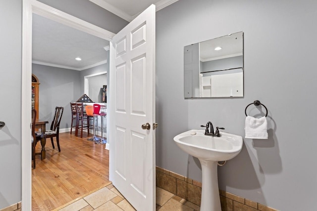 bathroom featuring hardwood / wood-style flooring and crown molding