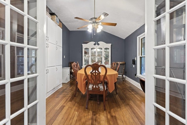 dining room featuring a textured ceiling, hardwood / wood-style floors, and lofted ceiling