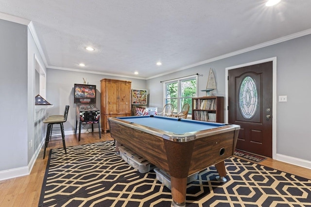 recreation room featuring light hardwood / wood-style floors, crown molding, and pool table