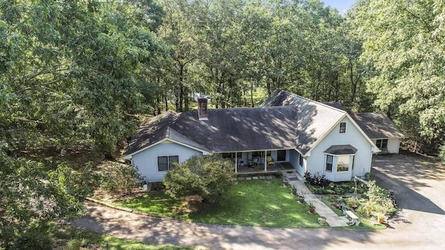 view of front of house with covered porch and a front yard