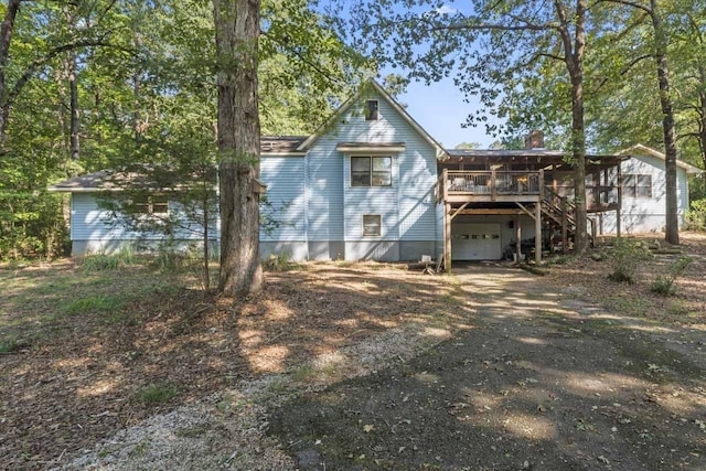 back of property featuring a wooden deck