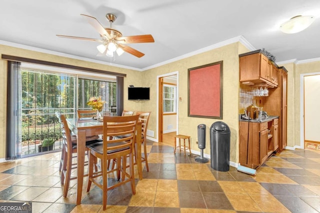 dining area featuring ceiling fan and ornamental molding