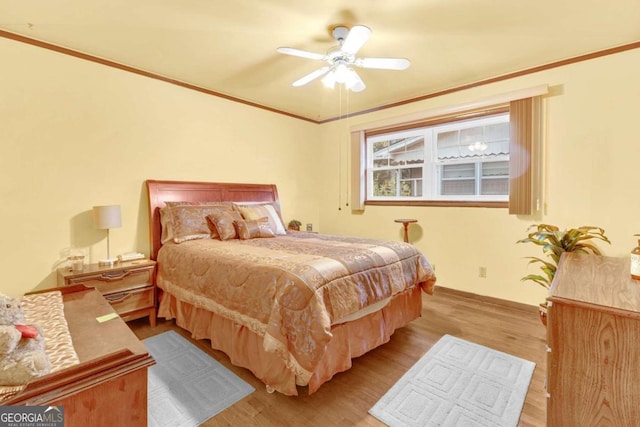 bedroom with ceiling fan, light hardwood / wood-style floors, and crown molding