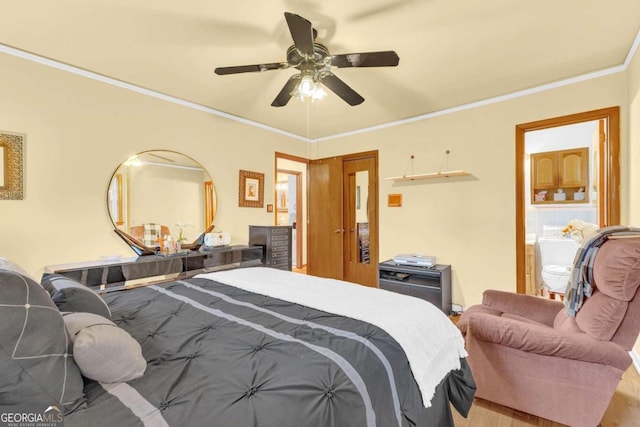 bedroom with hardwood / wood-style flooring, ceiling fan, connected bathroom, and crown molding