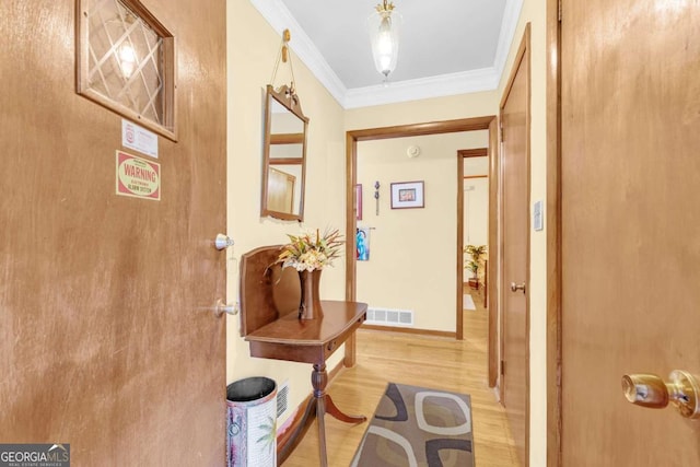 interior space with ornamental molding and wood-type flooring