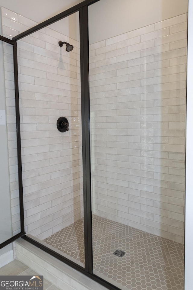 bathroom featuring a shower with shower door