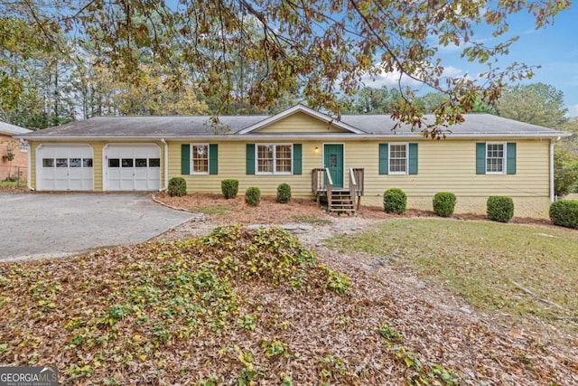 single story home with a garage and a front yard