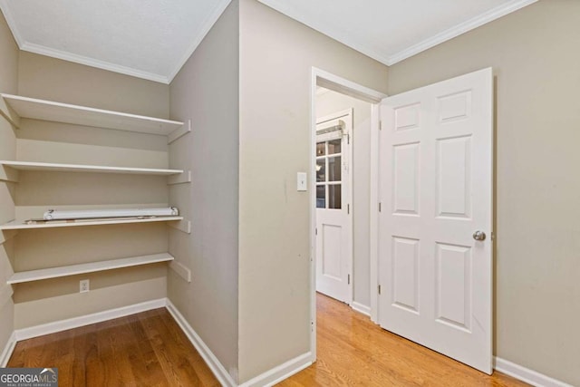 interior space featuring hardwood / wood-style flooring and ornamental molding