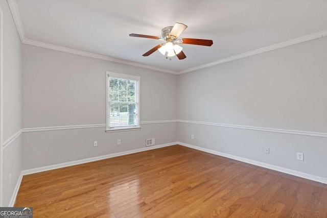 unfurnished room with hardwood / wood-style floors, ceiling fan, and crown molding