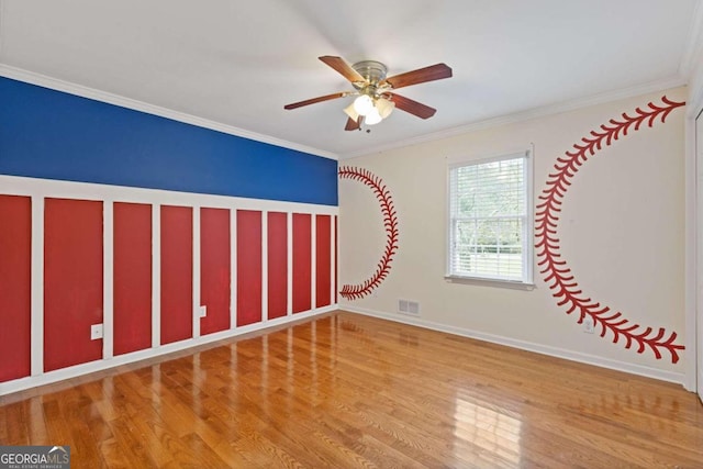 spare room with ceiling fan, light wood-type flooring, and crown molding