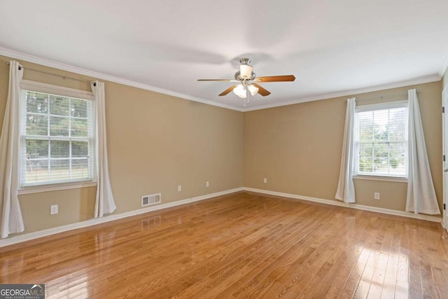 spare room with ceiling fan, light wood-type flooring, and crown molding