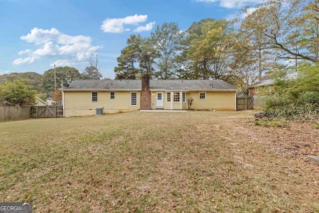 rear view of property featuring a patio area, a yard, and cooling unit