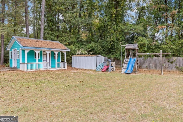 view of yard with a playground, a shed, and a porch