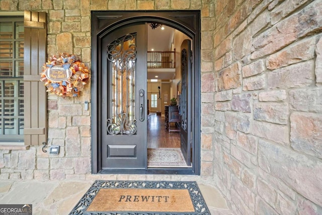 entryway with french doors, light hardwood / wood-style flooring, and lofted ceiling with beams