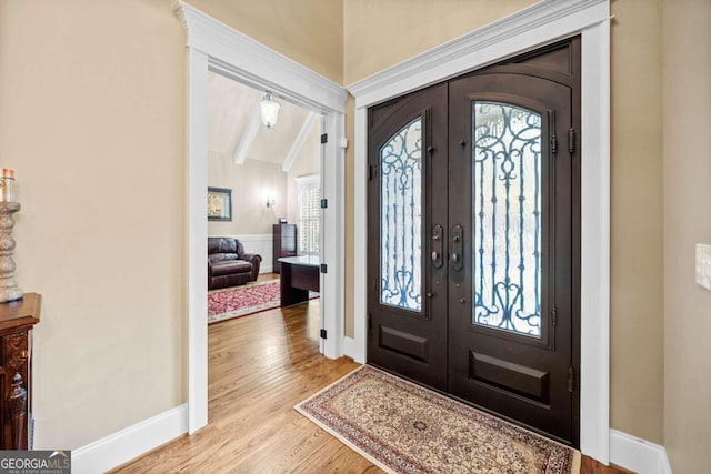 dining area with an inviting chandelier, beam ceiling, light hardwood / wood-style flooring, and crown molding