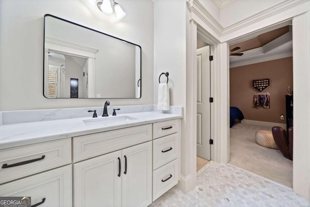 bedroom featuring light colored carpet, ceiling fan, crown molding, and a tray ceiling