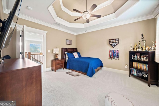 bedroom featuring carpet floors, ceiling fan, crown molding, and a tray ceiling