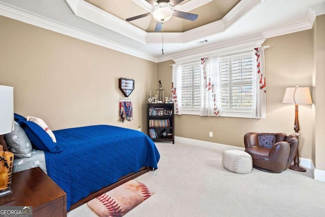 carpeted bedroom featuring ornamental molding, ceiling fan, and a raised ceiling