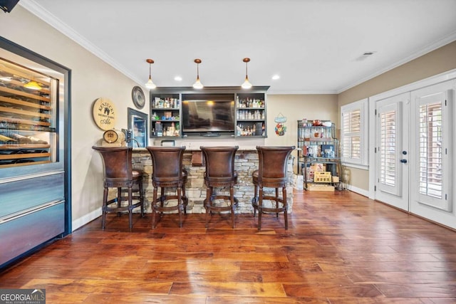 game room with ornamental molding, dark hardwood / wood-style flooring, and ceiling fan