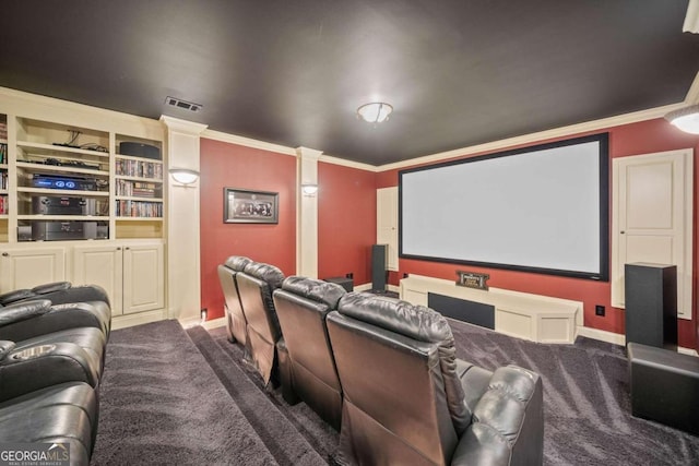 cinema with built in shelves, wood-type flooring, and crown molding