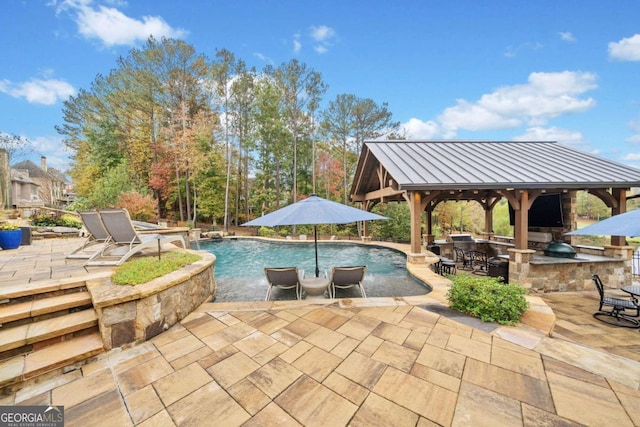 view of swimming pool with a patio, an in ground hot tub, and a water view