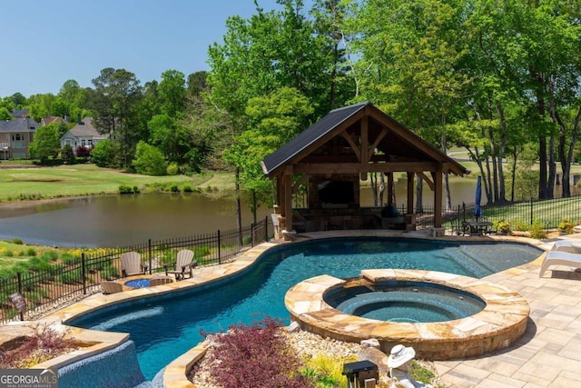 view of swimming pool featuring a water view, a patio, and an in ground hot tub