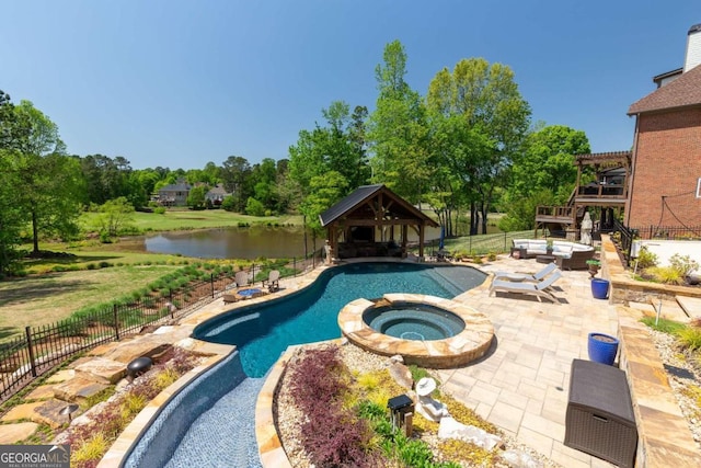 pool at twilight with an in ground hot tub, a gazebo, and a patio area