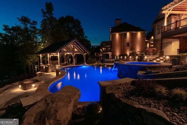 pool at dusk featuring a patio area, a water view, a gazebo, and an in ground hot tub