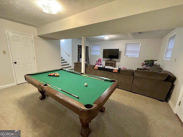 game room with light colored carpet, a textured ceiling, and billiards