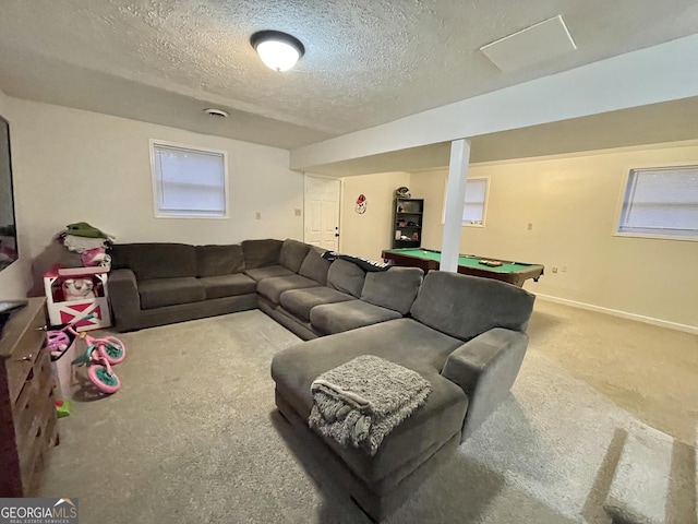 living room with carpet flooring, a textured ceiling, and pool table