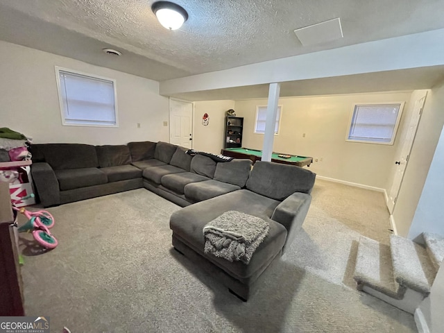 living room with carpet flooring, a textured ceiling, and pool table