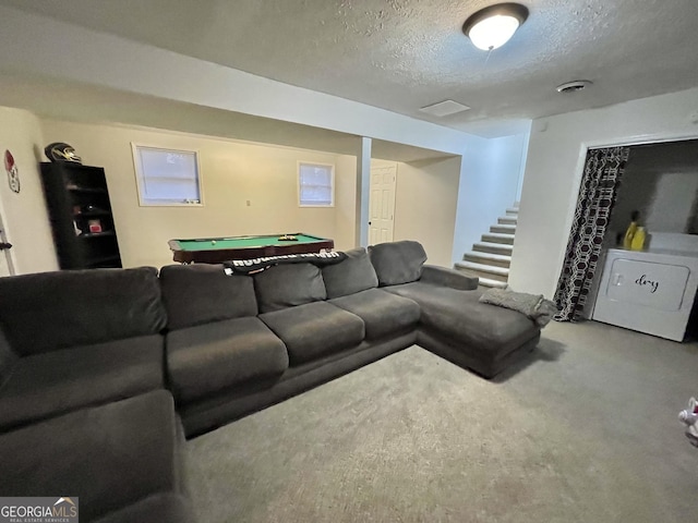 carpeted living room with a textured ceiling and pool table