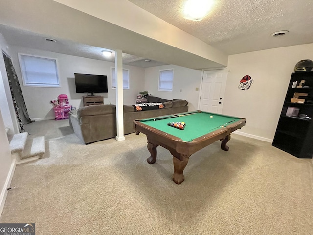 rec room with a textured ceiling, billiards, and light carpet