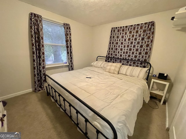 carpeted bedroom featuring a textured ceiling