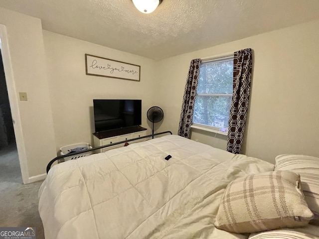 bedroom featuring carpet and a textured ceiling