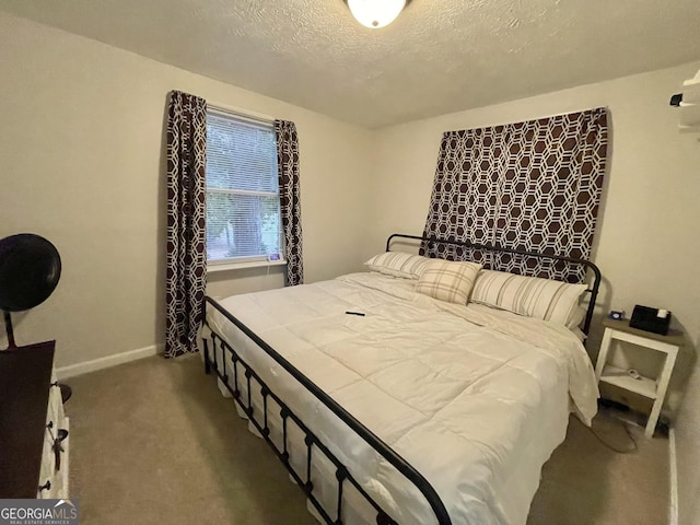 carpeted bedroom featuring a textured ceiling