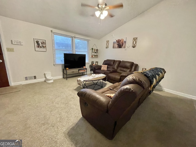 carpeted living room with ceiling fan and vaulted ceiling