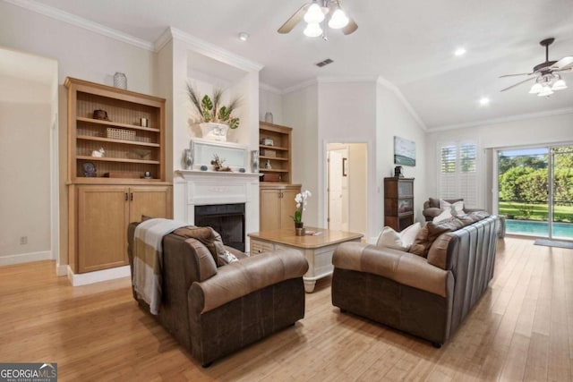 living room featuring ceiling fan, lofted ceiling, light hardwood / wood-style floors, and crown molding