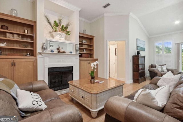 living room featuring crown molding, light hardwood / wood-style flooring, and lofted ceiling