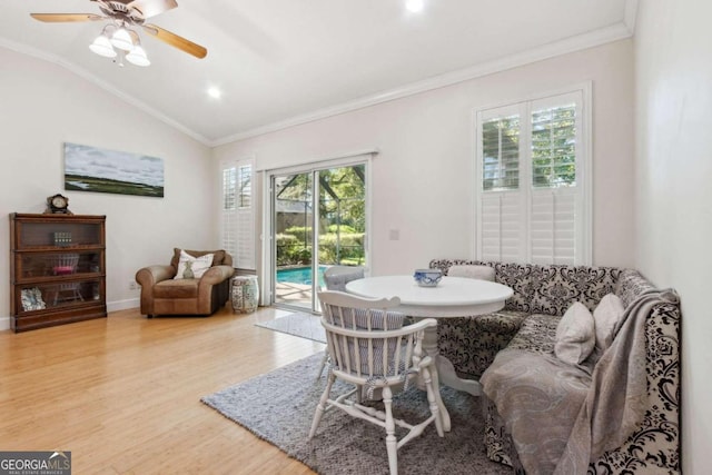 dining area with a wealth of natural light, hardwood / wood-style flooring, ceiling fan, and vaulted ceiling