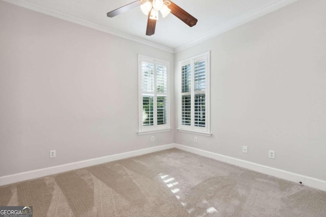 carpeted empty room featuring ceiling fan and ornamental molding