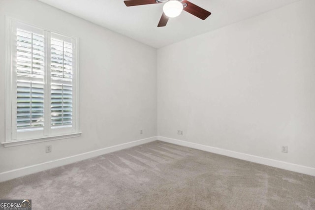 empty room featuring light carpet and ceiling fan