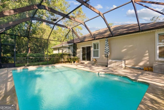 view of pool with a lanai and a patio