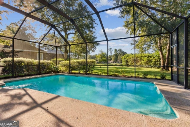 view of pool featuring glass enclosure and a patio