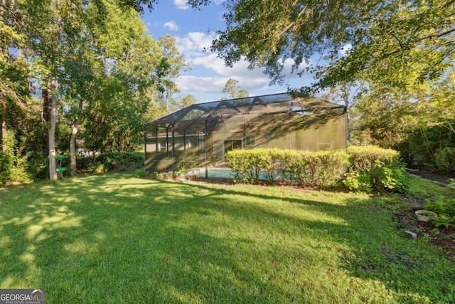 view of yard with glass enclosure