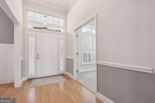 entrance foyer with light wood-type flooring and ornamental molding