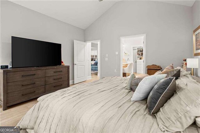 bedroom with high vaulted ceiling