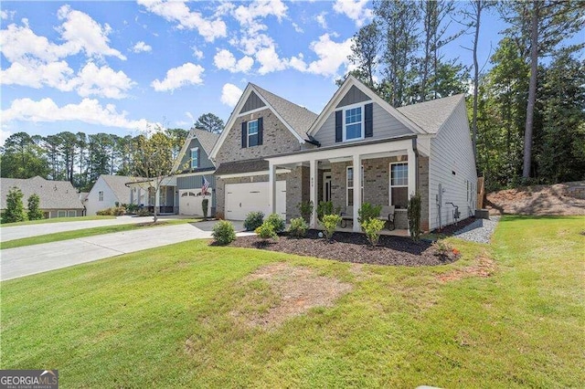 view of front of property featuring a front lawn, a garage, and covered porch